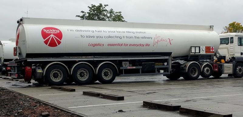 A white fuel tanker with gray text on the side.