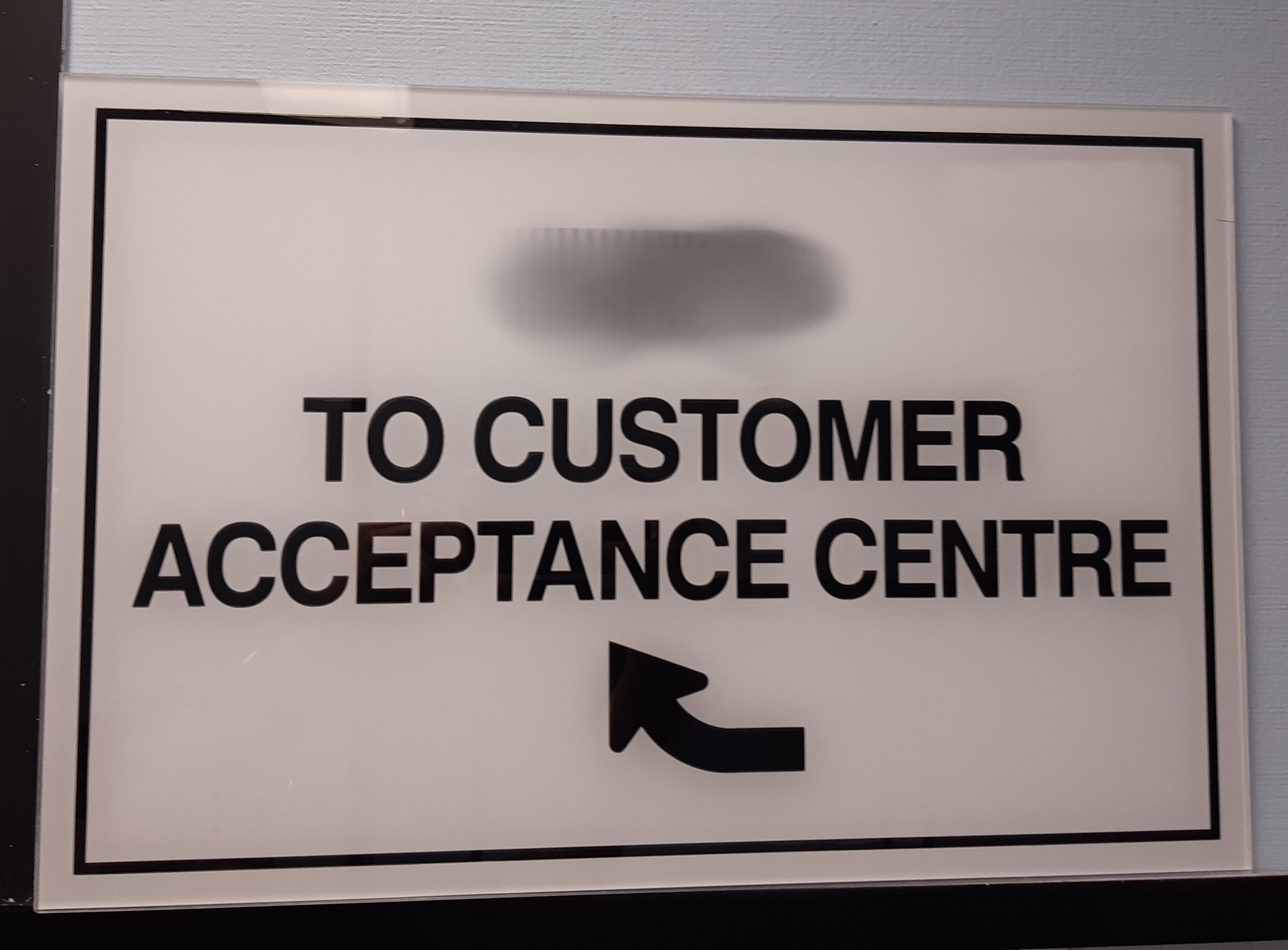 Acceptance Centre Sign directing 'To Customer Acceptance Centre'