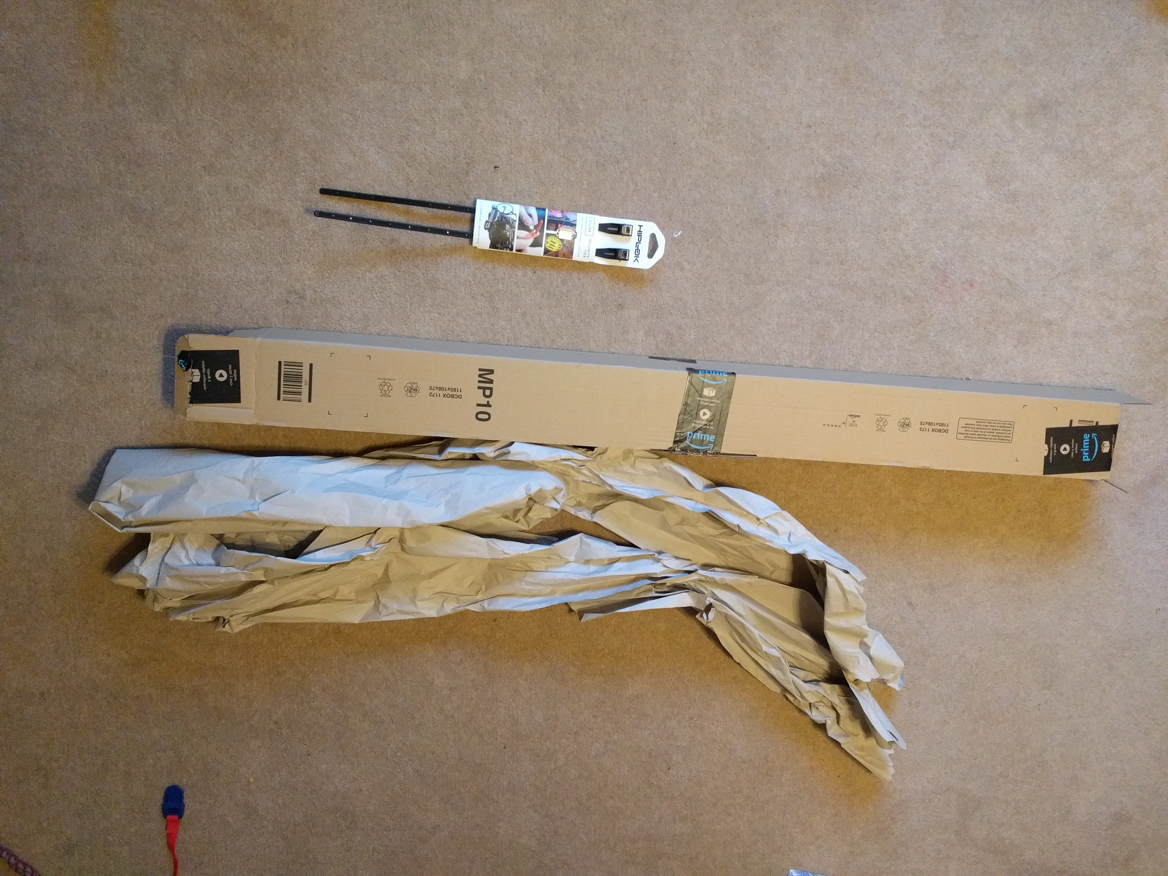 Small pacet of two cable ties next to very long cardboard box