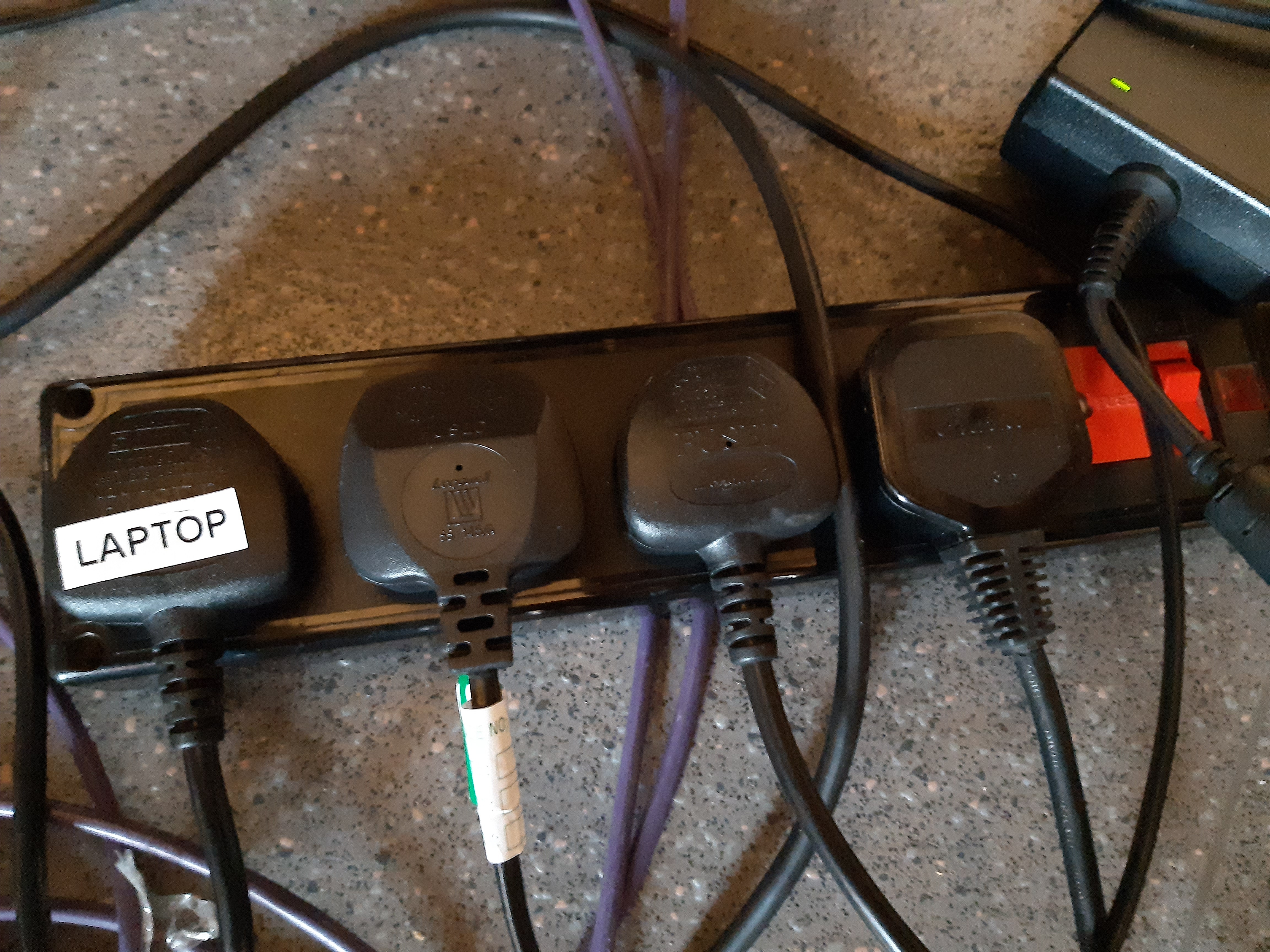 Four plugs in a row. One of which is labeled laptop.
