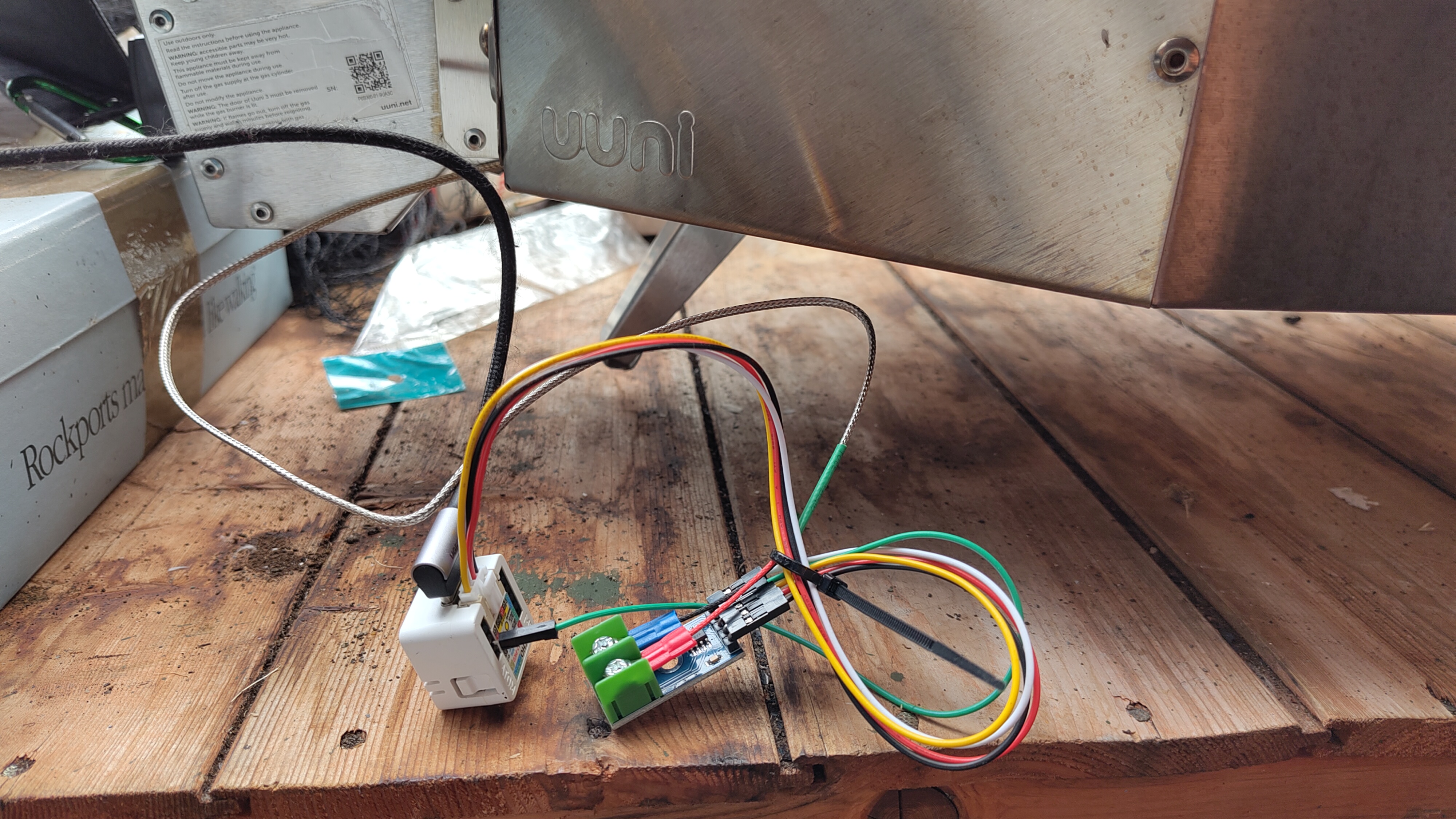 A mess of wires at the back of a pizza oven